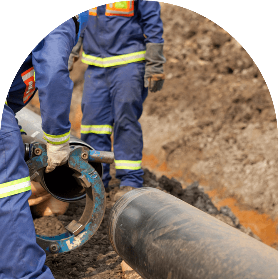 Workers wearing protective high visibility clothing fixing and joining industrial pipes — Blog in Auckland, NZ